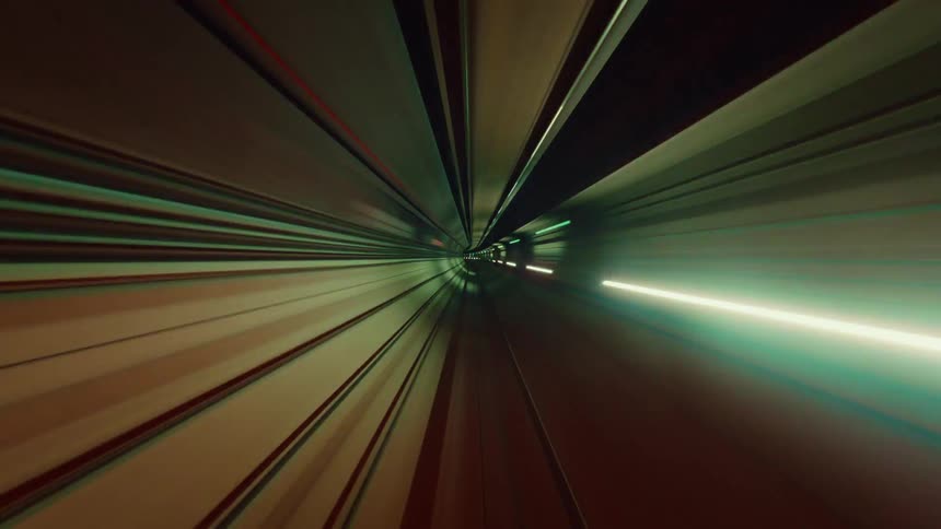A surreal, high-speed time-lapse journey through a futuristic subway tunnel with colorful light streaks creating an abstract, seamless loop