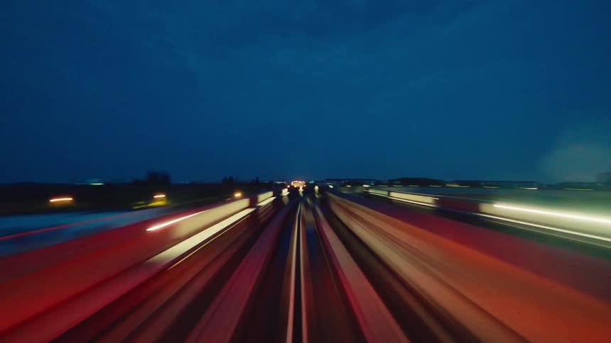 Experience a futuristic ride on a high-speed train at night through a dazzling city skyline in this stunning timelapse