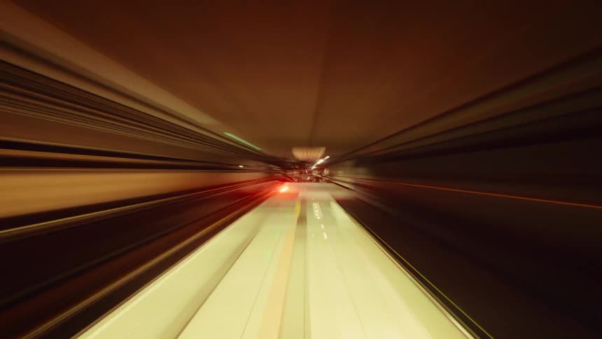 A futuristic and abstract point-of-view time-lapse of a high-speed journey through a colorful light tunnel
