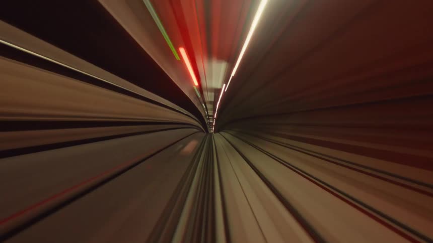 A psychedelic first-person view time-lapse of a train speeding through a futuristic tunnel with colorful blurred light trails