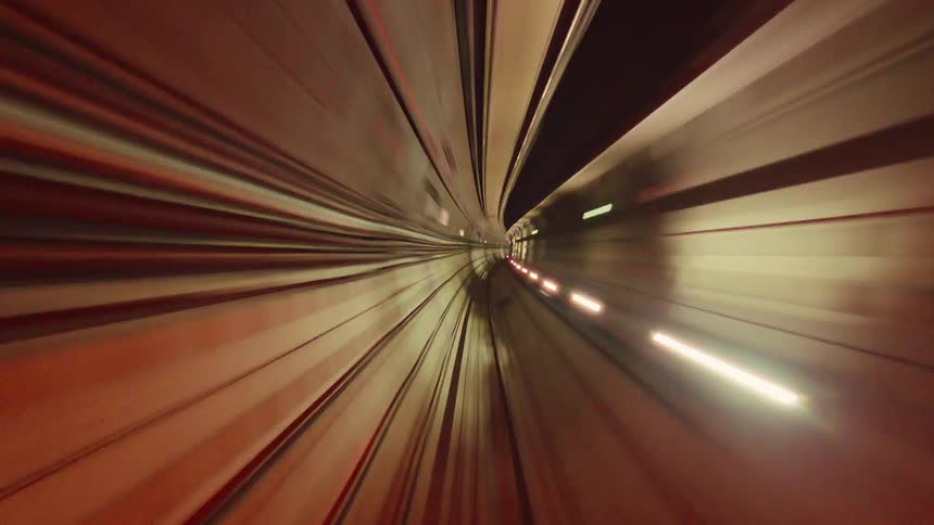 A psychedelic first-person view time-lapse of a train speeding through a futuristic tunnel with colorful blurred light trails