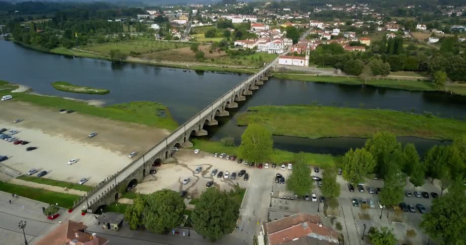 Aerial view of a bridge spanning a river between cities