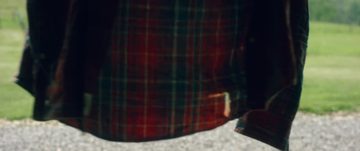 A flannel shirt hanging on a clothesline blows in the wind