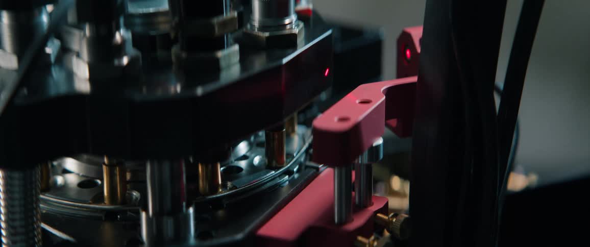 Slow motion close-up of a reloading press creating bullets in an automated process