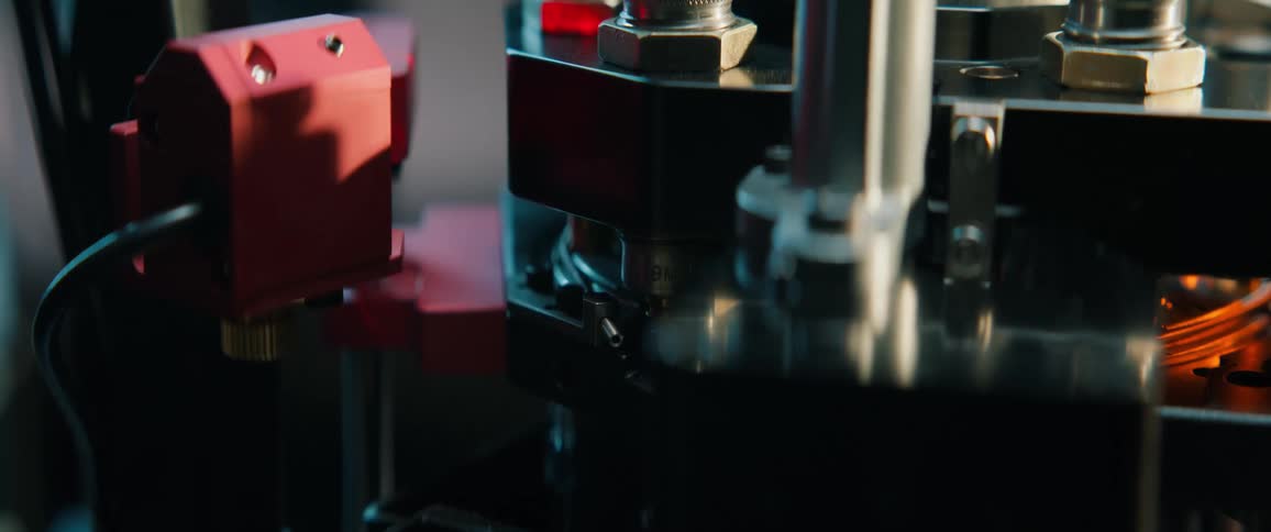 Close-up slow-motion view of an automated machine manufacturing bullets on a production line