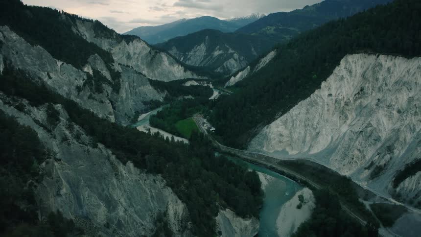 An expansive aerial view captures the dramatic beauty of a deep river gorge nestled between forested mountains