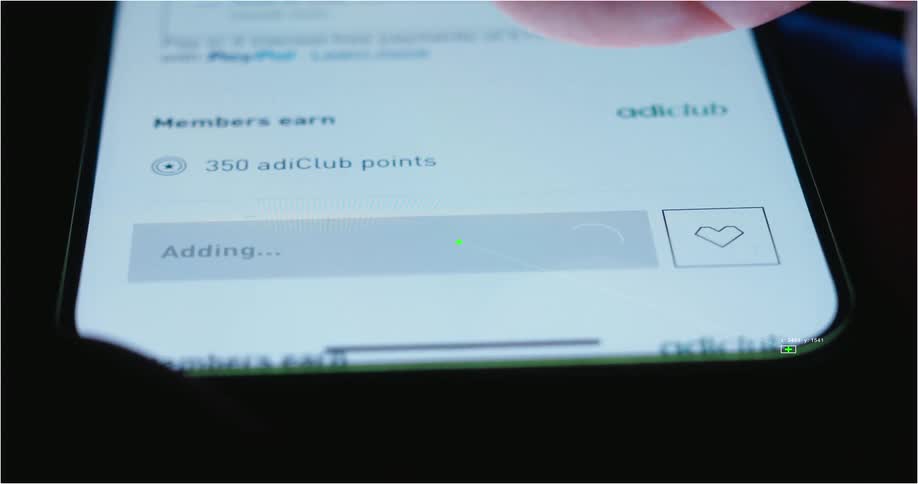 Visual effects track a user's finger as they add an item to their online shopping cart on a smartphone