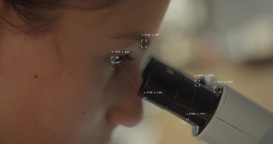 Futuristic data analysis graphics track a child's eye as they look into a microscope in a laboratory