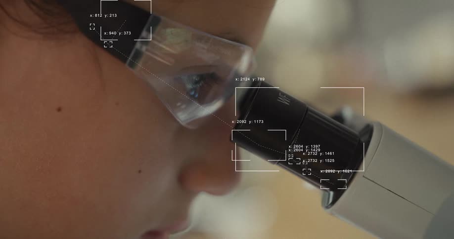 Futuristic technology tracks a scientist's eye as they look through a microscope for research