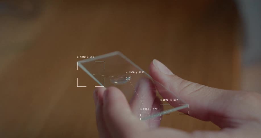 Futuristic digital interface analyzes a scientist preparing a liquid sample on a microscope slide