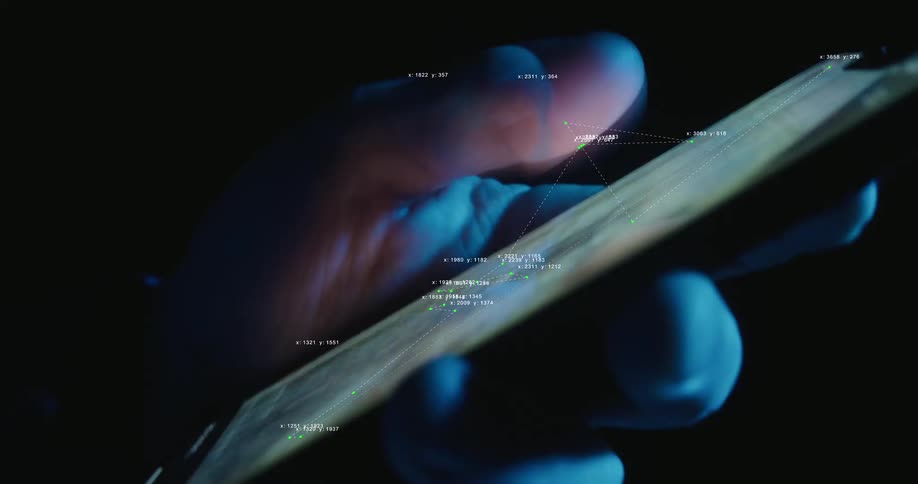 A close-up shot of a hand scrolling on a smartphone at night with futuristic data graphics overlaid on the screen