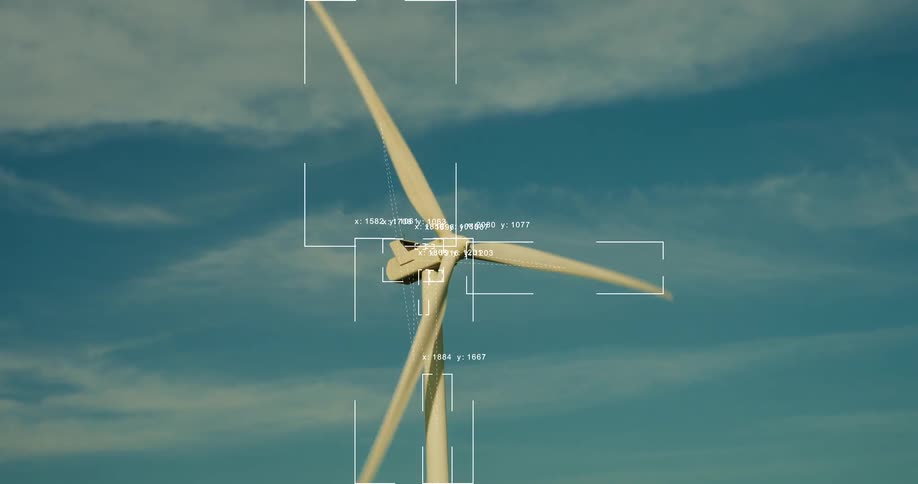 A futuristic heads-up display shows real-time analytics of a spinning wind turbine generating clean energy