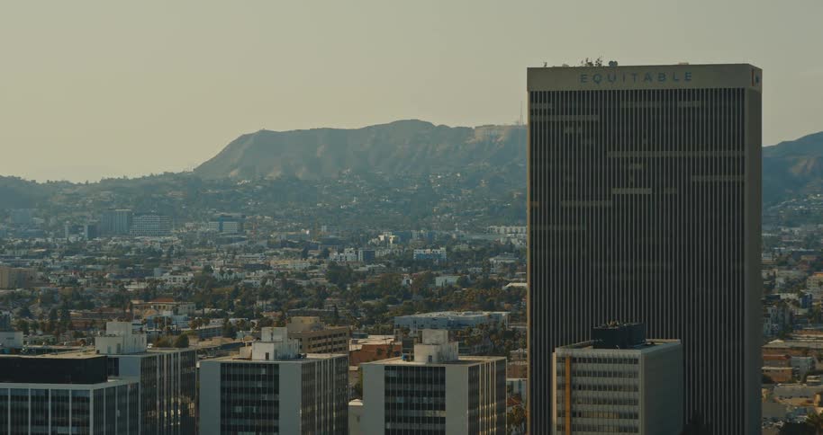 A slow zoom establishing shot reveals the iconic Hollywood Hills behind the Equitable Building in the Los Angeles cityscape