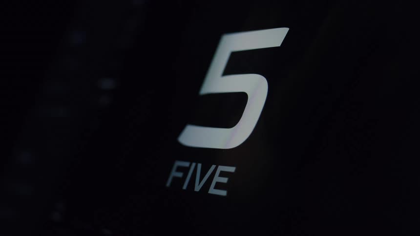 A sleek and modern digital timer counts down from ten to zero on a black screen
