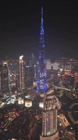 An awe-inspiring aerial night view of the illuminated Burj Khalifa and the sprawling Dubai cityscape