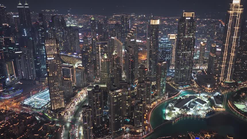 Breathtaking aerial view of the vibrant, illuminated skyscrapers and cityscape of Downtown Dubai at night