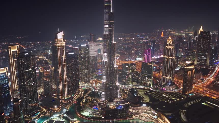 Stunning aerial view of the illuminated Burj Khalifa and the sprawling Dubai skyline at night