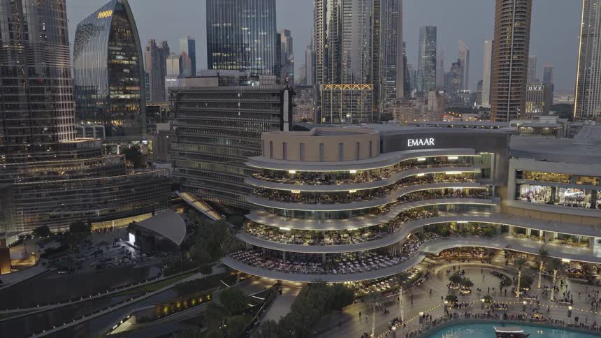 Stunning evening timelapse of the iconic Dubai cityscape, featuring the illuminated Emaar building and bustling city life
