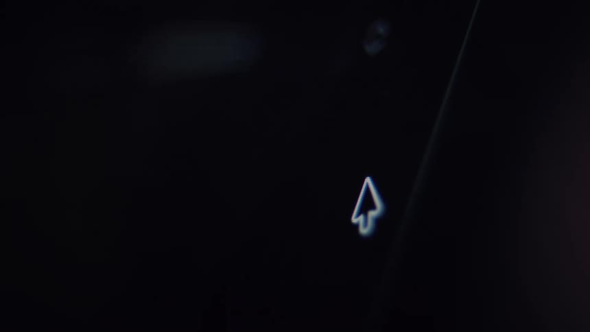 A close-up of a mouse cursor clicking a blue send or upload button on a dark computer screen