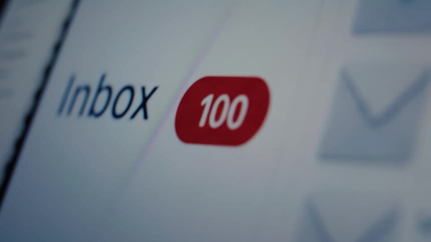 A close-up on a screen shows an email inbox where the number of unread messages quickly climbs into the thousands, creating a sense of being overwhelmed