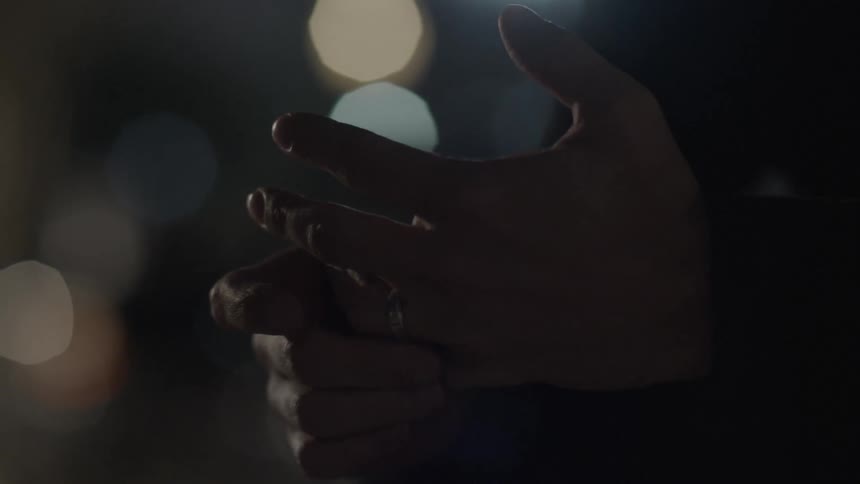 A person wraps their hands at night
