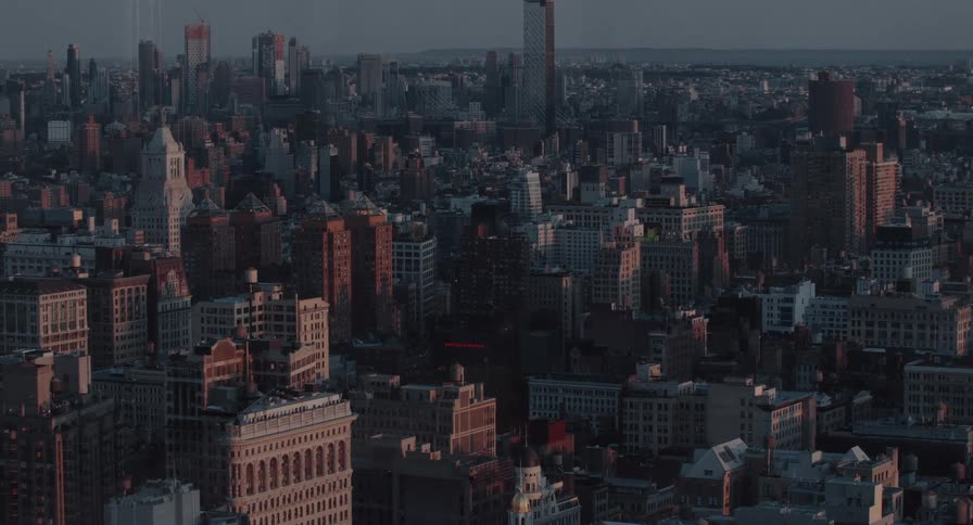 A timelapse of the New York City skyline at dusk, with the last rays of sunlight moving across the buildings and streets below
