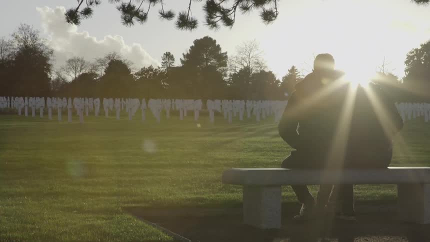 A man and woman sit on a bench together