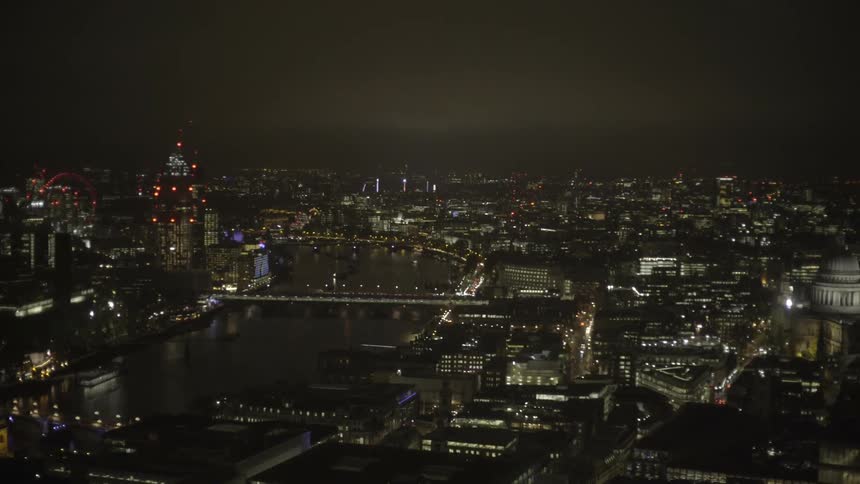 City buildings illuminate the dark night