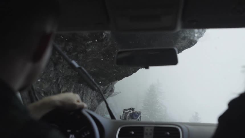 Man driving in foggy snowy conditions