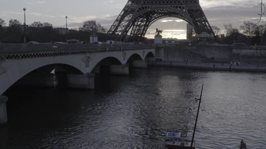 Cars travel over a bridge at dawn