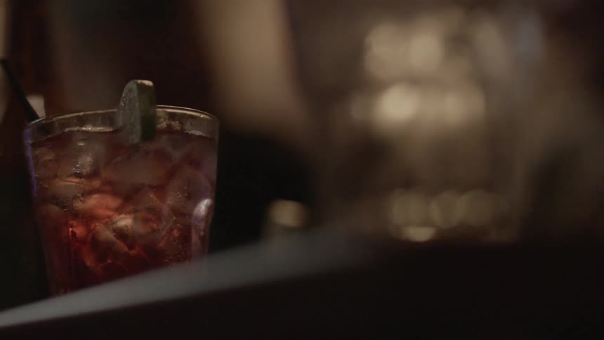 A drink with a lime sits on the table