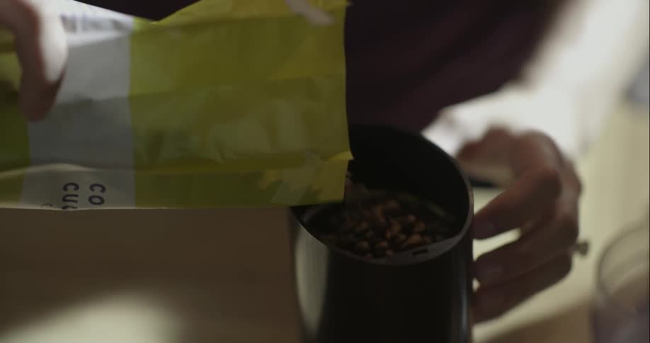 Man pouring contents from a bag into a container