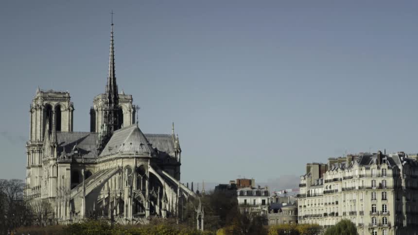 A large stone building has two towers on either side