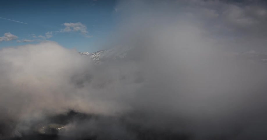 The clouds spin and move around the top of the mountain