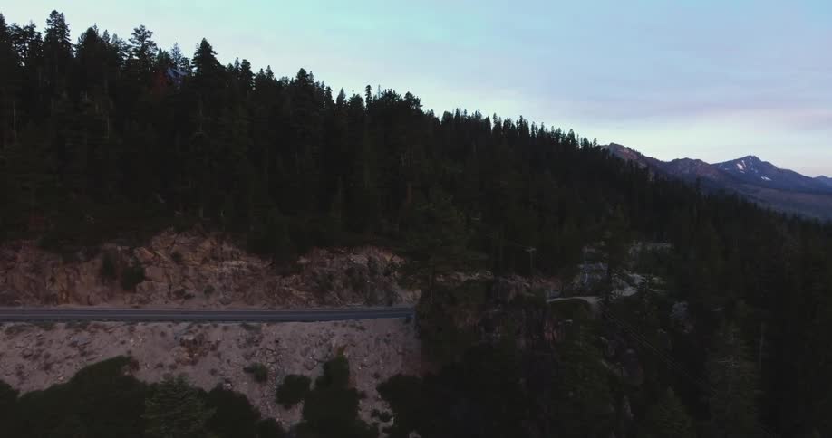 A car travels on a road on a mountain