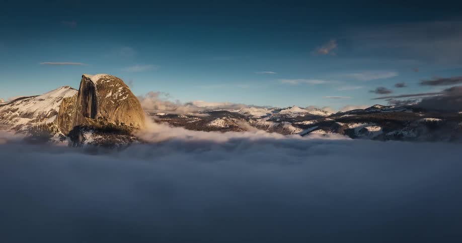 The clouds move slowly over the mountain