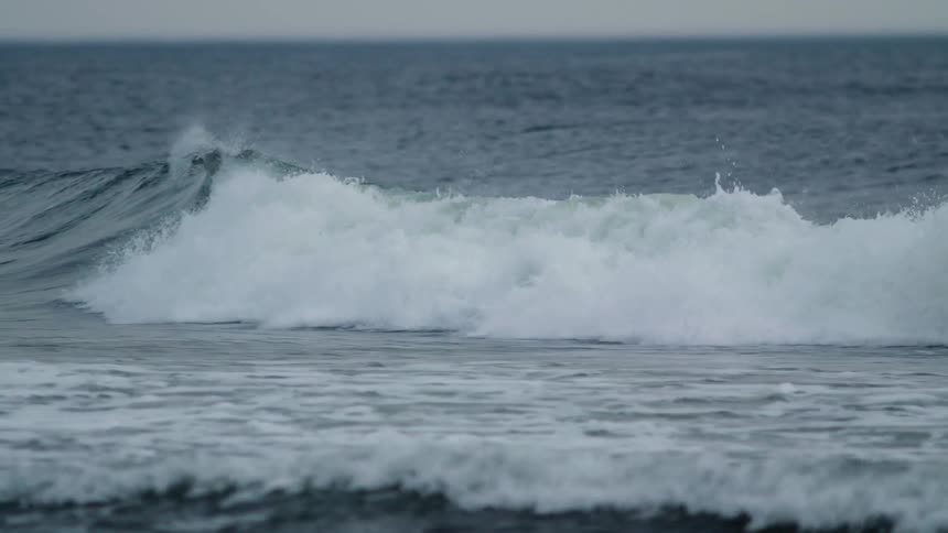 Waves rolling in towards a shoreline