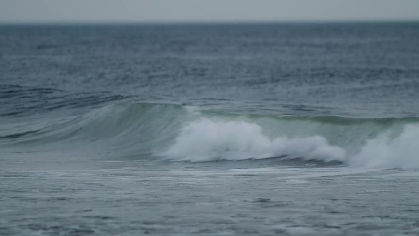 The waves move slowly in the ocean