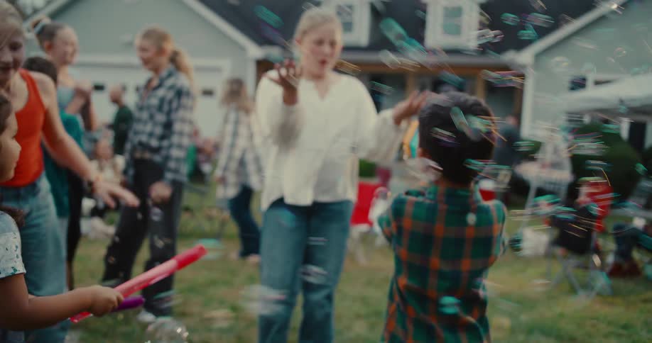 A diverse group of happy children play together in a backyard, surrounded by a whirlwind of bubbles from a toy bubble gun
