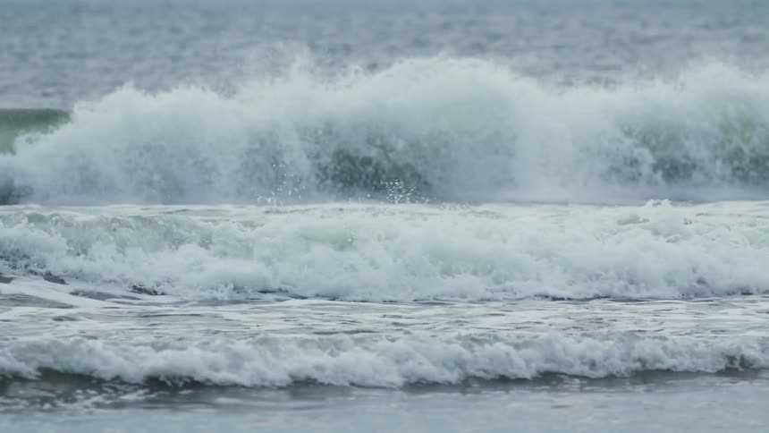 Waves rolling in towards a shoreline