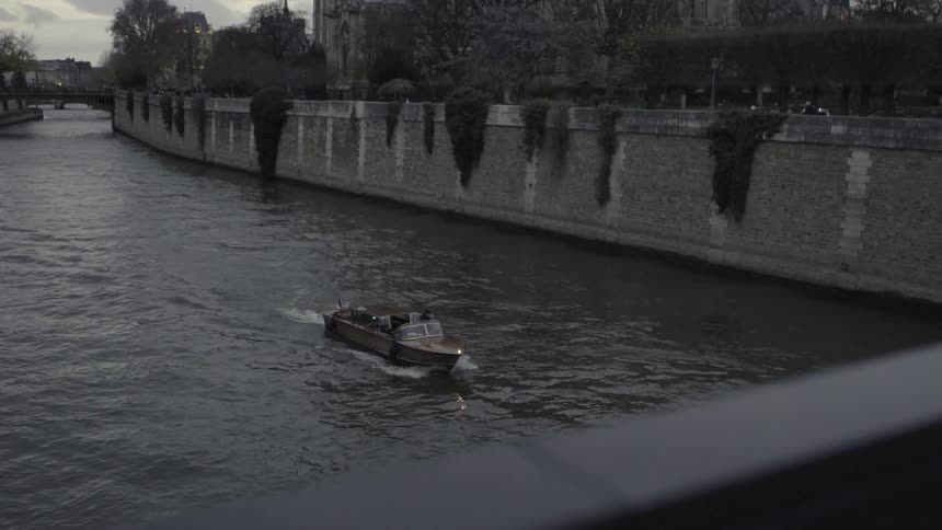 A boat sails towards a bridge below