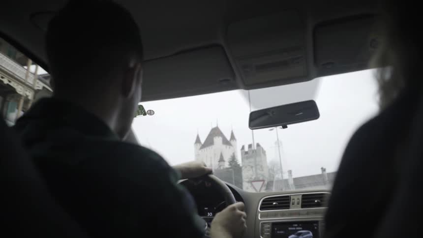 A man drives a car in a city