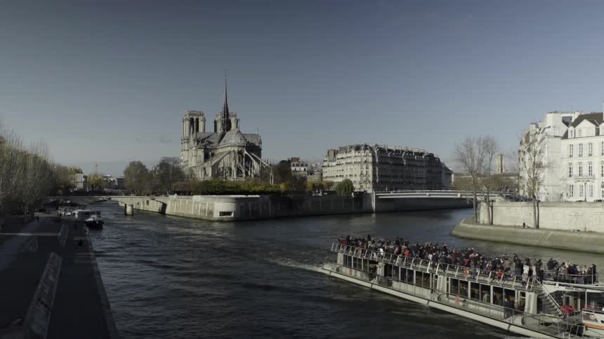 A large boat carries people in the canal