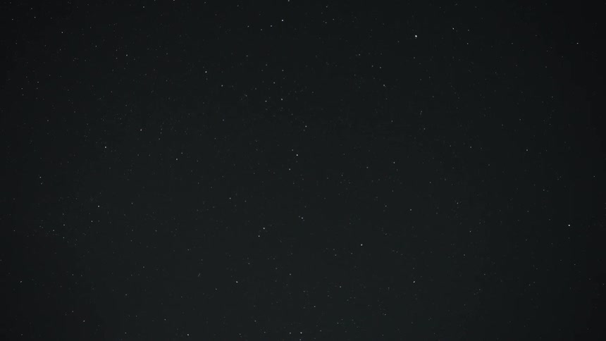 A clear, dark night sky is filled with thousands of twinkling stars