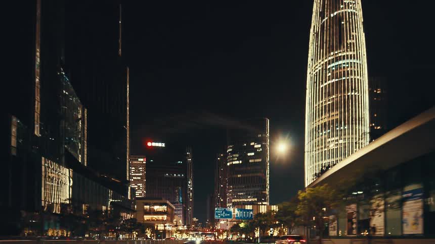A mesmerizing drive through a futuristic cityscape at night, surrounded by towering, illuminated skyscrapers