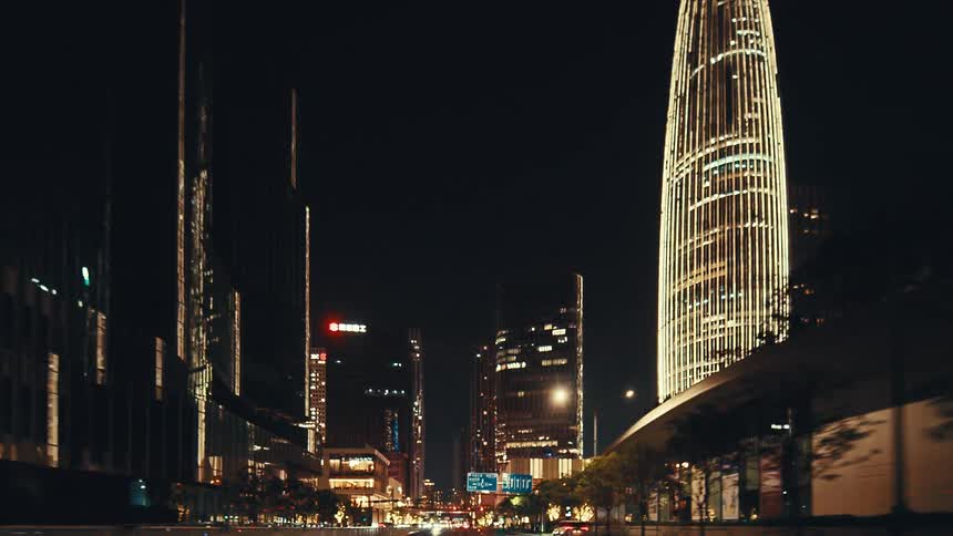 A mesmerizing drive through a futuristic cityscape at night, surrounded by towering, illuminated skyscrapers