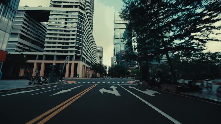 A cinematic forward dolly shot through an empty, modern city street surrounded by towering skyscrapers and unique architecture