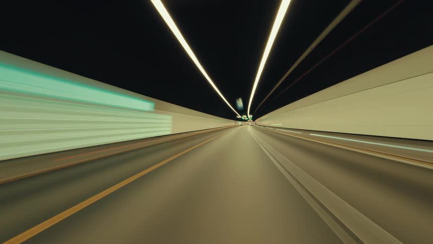 A futuristic time-lapse journey through an illuminated highway tunnel at high speed