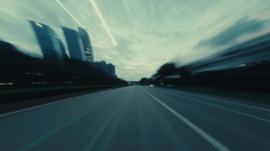 A stylized hyper-lapse journey from a driver's perspective on a city highway at dusk, speeding through a brightly lit tunnel