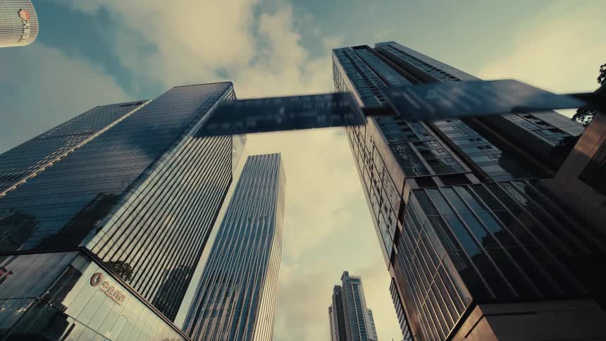 A smooth, low-angle journey through a modern metropolis reveals towering glass skyscrapers reaching for the sky